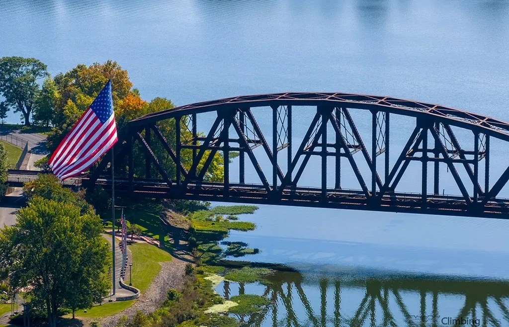 A bridge with an american flag flying over it.